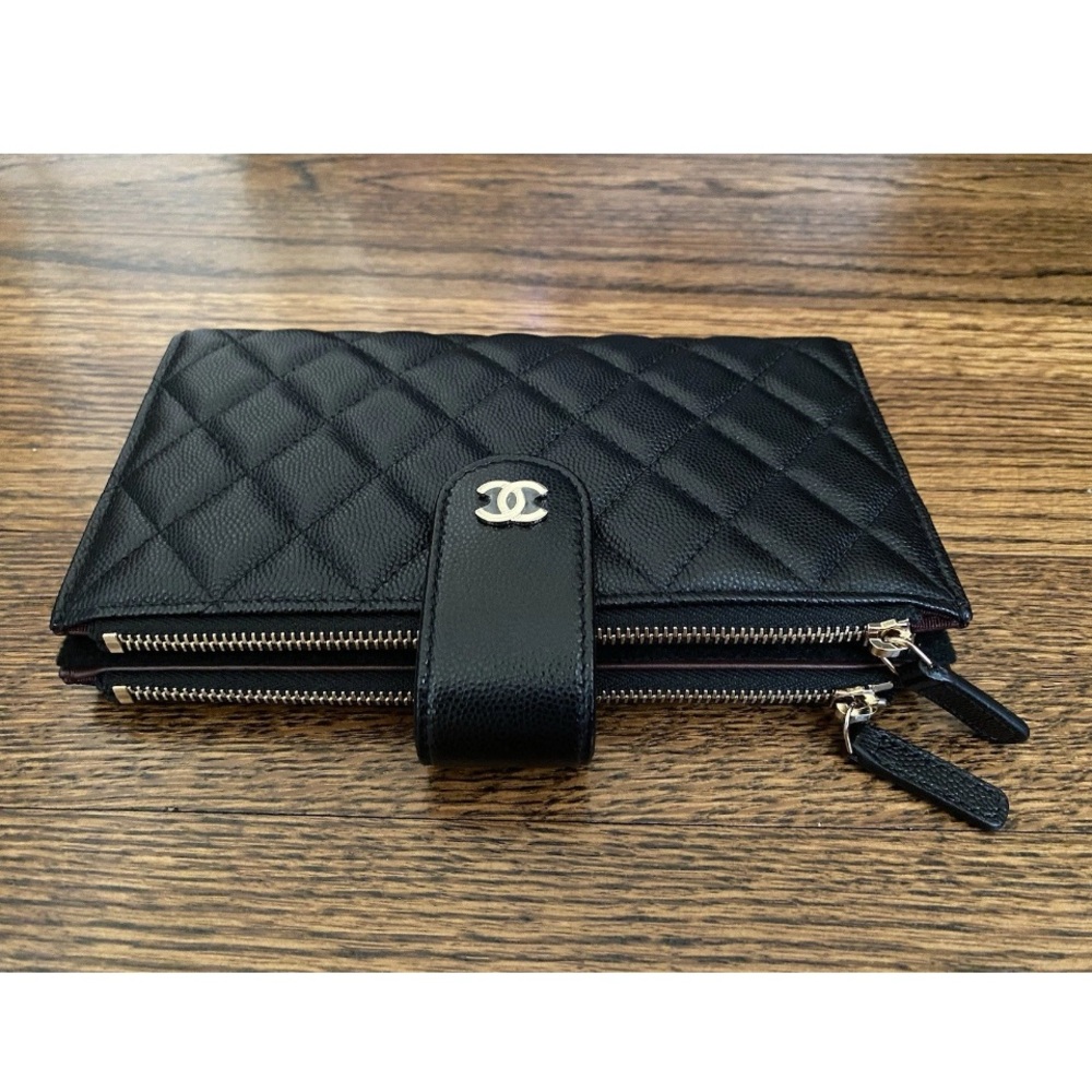CHANEL Black Quilted Wallet with Gold hardware.